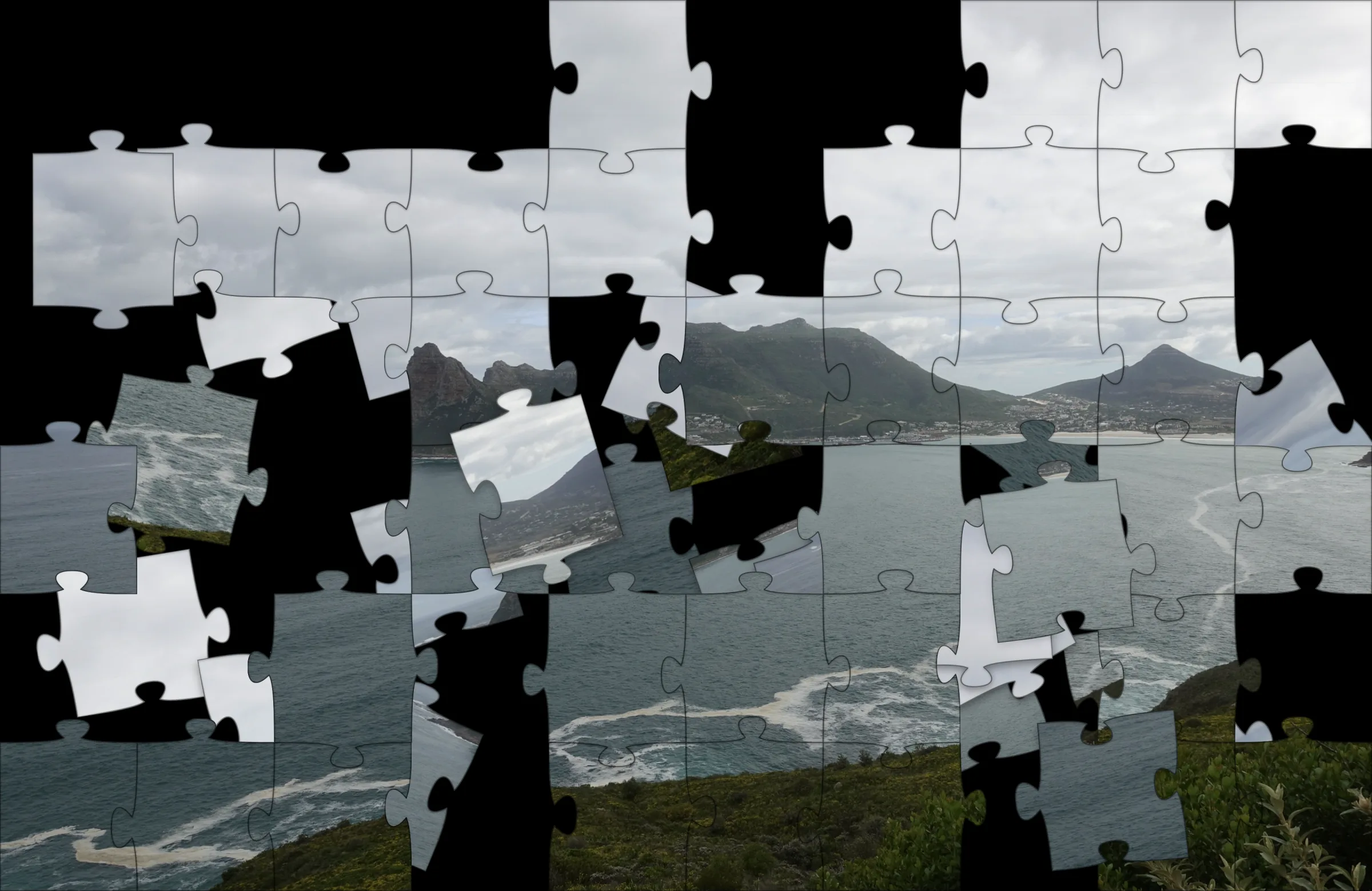 Puzzle: a coastal landscape photo broken into jigsaw pieces, half reassembled